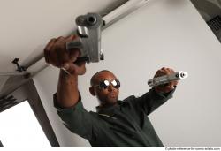 ERIC STANDING POSE WITH GUNS